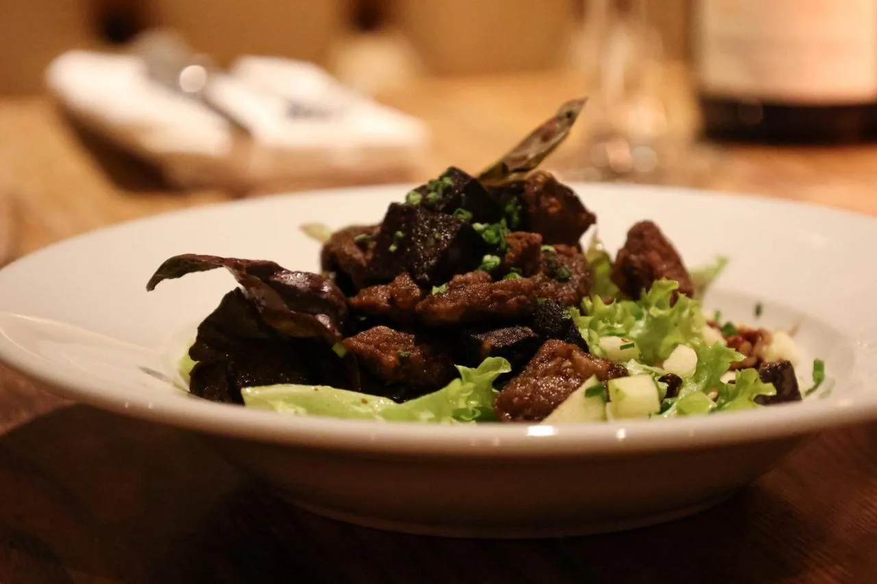 a white bowl of food on a table at The Porterhouse Grill and Rooms in Oxford